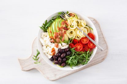 ketogenic lunch bowl: spiralized courgette with avocado, tomato, feta cheese, olives, bacon