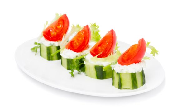 Cucumber Bites with Cream Herb  Cheese and Cherry Tomatoes isolated on white