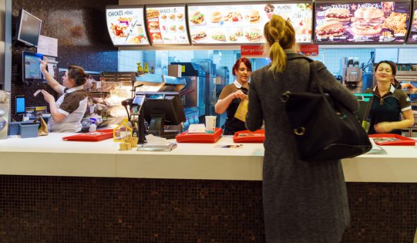 Munich, Germany - October 24, 2017: The girl receives an order in the interior of the McDonald's fast-food restaurant